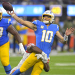 Los Angeles Chargers quarterback Justin Herbert, right, throws for an incomplete pass as Kansas City Chiefs defensive tackle Chris Jones tackles him during the first half of an NFL football game Sunday, Nov. 20, 2022, in Inglewood, Calif. (AP Photo/Jayne Kamin-Oncea)