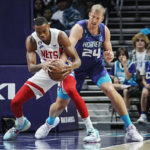 
              Brooklyn Nets forward Nic Claxton, left, works to retain possession against Charlotte Hornets center Mason Plumlee during the first half of an NBA basketball game, Saturday, Nov. 5, 2022, in Charlotte, N.C. (AP Photo/Rusty Jones)
            