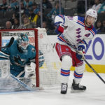New York Rangers center Barclay Goodrow (21) skates with the puck in front of San Jose Sharks goaltender James Reimer during the second period of an NHL hockey game in San Jose, Calif., Saturday, Nov. 19, 2022. (AP Photo/Jeff Chiu)
