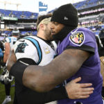 
              Baltimore Ravens quarterback Lamar Jackson, right, hugs Carolina Panthers quarterback Baker Mayfield, left, after an NFL football game Sunday, Nov. 20, 2022, in Baltimore. (AP Photo/Nick Wass)
            