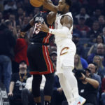 
              Cleveland Cavaliers guard Donovan Mitchell, right, makes a steal against Miami Heat center Bam Adebayo (13) during the first half of an NBA basketball game, Sunday, Nov. 20, 2022, in Cleveland. (AP Photo/Ron Schwane)
            