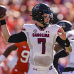 South Carolina quarterback Spencer Rattler (7) passes the ball in the first half of an NCAA college football game against Clemson on Saturday, Nov. 26, 2022, in Clemson, S.C. (AP Photo/Jacob Kupferman)