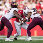 
              Minnesota defensive back Justin Walley (5) and defensive back Jordan Howden (23) tackle Wisconsin running back Chez Mellusi (1) during the first half of an NCAA college football game Saturday, Nov. 26, 2022, in Madison, Wis. (AP Photo/Andy Manis)
            