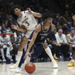 
              Mount St. Mary's guard Dakota Leffew (1) is defended by West Virginia forward Tre Mitchell (3) during the first half of an NCAA college basketball game in Morgantown, W.Va., Monday, Nov. 7, 2022. (AP Photo/Kathleen Batten)
            