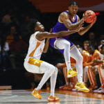 
              Tennessee Tech guard Jayvis Harvey (13) grabs a pass as he's defended by Tennessee forward Julian Phillips (2) during the first half of an NCAA college basketball game Monday, Nov. 7, 2022, in Knoxville, Tenn. (AP Photo/Wade Payne)
            