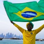 
              Brazil fan Ajmal Pial, of Khulna, Bangladesh, waves the Brazilian flag in Doha, Qatar, Friday, Nov. 18, 2022. Fans poured into Qatar on Friday ahead of the Middle East's first World Cup as Doha ordered beers not to be poured out at stadiums during the tournament — a last-minute surprise largely welcomed by the country's conservative Muslims and shrugged off by giddy fans. (AP Photo/Jon Gambrell)
            