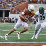
              Texas quarterback Quinn Ewers (3) runs past Baylor linebacker Jackie Marshall (35) for a touchdown during the first half of an NCAA college football game in Austin, Texas, Friday, Nov. 25, 2022. (AP Photo/Eric Gay)
            