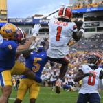
              Syracuse defensive back Ja'Had Carter (1) intercepts a pass intended for Pittsburgh tight end Karter Johnson (8) during the first half of an NCAA college football game, Saturday, Nov. 5, 2022, in Pittsburgh. (AP Photo/Barry Reeger)
            