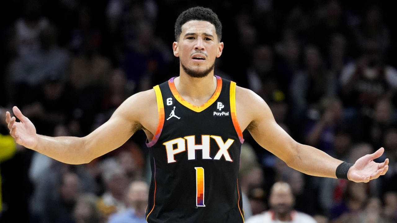 Phoenix Suns guard Devin Booker (1) reacts to a traveling call during the first half of an NBA bask...