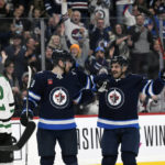 Winnipeg Jets' Pierre-Luc Dubois (80) celebrates his goal against the Dallas Stars with Dylan DeMelo (2) during the second period of an NHL hockey game, Tuesday, Nov. 8, 2022 in Winnipeg, Manitoba. (Fred Greenslade/The Canadian Press via AP)
