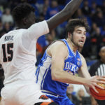 
              Duke center Ryan Young, right, drives to the basket against Oregon State center Chol Marial, left, during the first half of an NCAA college basketball game in the Phil Knight Legacy tournament in Portland, Ore., Thursday, Nov. 24, 2022. (AP Photo/Craig Mitchelldyer)
            