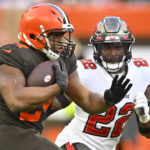 Cleveland Browns running back Nick Chubb, left, carries the ball with Tampa Bay Buccaneers safety Keanu Neal (22) on defense during the second half of an NFL football game in Cleveland, Sunday, Nov. 27, 2022. (AP Photo/David Richard)