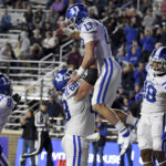 Duke quarterback Riley Leonard (13) is lifted by center Jack Burns after scoring a touchdown during the first half of an NCAA college football game against Boston College, Friday, Nov. 4, 2022 in Boston. (AP Photo/Mark Stockwell)