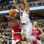 Missouri's Tre Gomillion, right, tries to block the shot of Southern Indiana's Tyler Henry, left, during the first half of an NCAA college basketball game Saturday, Nov. 7, 2022, in Columbia, Mo. (AP Photo/L.G. Patterson)