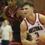 San Diego State guard Micah Parrish (3) chases Arizona guard Pelle Larsson (3) during the first half of an NCAA college basketball game, Tuesday, Nov. 22, 2022, in Lahaina, Hawaii. (AP Photo/Marco Garcia)