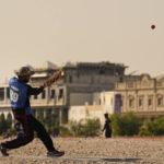 People play cricket in the streets in Doha, Qatar, Friday, Nov. 25, 2022. As dawn broke Friday as Qatar hosts the World Cup, the laborers who built this energy-rich country's stadiums, roads and rail filled empty stretches of asphalt and sandlots to play cricket. (AP Photo/Abbie Parr)