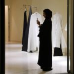 
              FILE - A woman takes photo with her mobile phone at the "Wadha Concept Store" located at the Qatar National Museum venue in Doha, Qatar, Sunday, April 27, 2019. Qatar has sought to portray itself as welcoming foreigners to this hereditarily ruled emirate, where traditional Muslim values remain strong.(AP Photo/Kamran Jebreili, File)
            