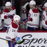 
              Montreal Canadiens center Nick Suzuki (14) celebrates with teammates after scoring his goal during the second period of an NHL hockey game against the Chicago Blackhawks in Chicago, Friday, Nov. 25, 2022. (AP Photo/Nam Y. Huh)
            