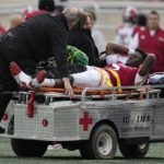 
              Indiana quarterback Dexter Williams II is carted off the field after getting injured during the first half of an NCAA college football game against Purdue, Saturday, Nov. 26, 2022, in Bloomington, Ind. (AP Photo/Darron Cummings)
            