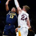 Michigan's Jett Howard (13) shoots over Arizona State's Duke Brennan (24) during the first half of an NCAA college basketball game in the championship round of the Legends Classic Thursday, Nov. 17, 2022, in New York. (AP Photo/Frank Franklin II)