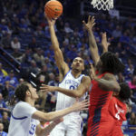 Kentucky's Jacob Toppin (0) shoots while defended by Duquesne's Tre Williams, right, and Quincy McGriff, second from right, during the first half of an NCAA college basketball game in Lexington, Ky., Friday, Nov. 11, 2022. (AP Photo/James Crisp)