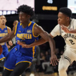 Vanderbilt guard Noah Shelby (2) reaches in on Morehead State's Drew Thelwell, left, in the second half of an NCAA college basketball game Friday, Nov. 18, 2022, in Nashville, Tenn. (AP Photo/Mark Humphrey)