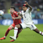 Wales' Neco Williams, left, challenges for the ball with Weston McKennie of the United States during the World Cup, group B soccer match between the United States and Wales, at the Ahmad Bin Ali Stadium in Doha, Qatar, Monday, Nov. 21, 2022. (AP Photo/Ashley Landis)