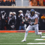 West Virginia tight end Brian Polendey (88) runs with the ball during the first quarter the NCAA college football game against Oklahoma State in Stillwater, Okla., Saturday Nov. 26, 2022. (AP Photo/Mitch Alcala)