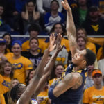 
              West Virginia's Jimmy Bell Jr., right, shoots over Pittsburgh's Federiko Federiko, left, during the first half of an NCAA college basketball game, Friday, Nov. 11, 2022, in Pittsburgh. (AP Photo/Keith Srakocic)
            
