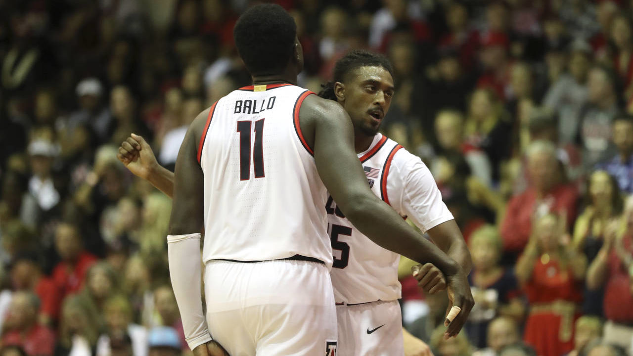 Arizona center Oumar Ballo (11) reacts with guard Cedric Henderson Jr., after he scored against San...