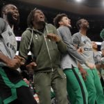 The Boston Celtics bench, including Jaylen Brown left, and Marcus Smart, second from right, react to a three-pointer by Jayson Tatum during the first half of an NBA basketball game against the Denver Nuggets, Friday, Nov. 11, 2022, in Boston. (AP Photo/Michael Dwyer)