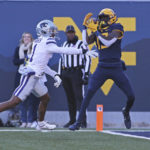 West Virginia wide receiver Sam James (13) catches a touchdown pass while defended by Kansas State safety Josh Hayes (1) during the first half of an NCAA college football game in Morgantown, W.Va., Saturday, Nov. 19, 2022. (AP Photo/Kathleen Batten)
