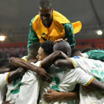 Senegal players celebrate scoring their side's second goal during the World Cup group A soccer match between Ecuador and Senegal, at the Khalifa International Stadium in Doha, Qatar, Tuesday, Nov. 29, 2022. (AP Photo/Francisco Seco)