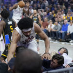 
              Cleveland Cavaliers center Jarrett Allen falls over rows of fans during the first half of the team's NBA basketball game against the Golden State Warriors in San Francisco, Friday, Nov. 11, 2022. (AP Photo/Jeff Chiu)
            