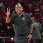 Houston coach Kellen Sampson signals to the officials during the first half of an NCAA college basketball game against Oral Roberts Monday, Nov. 14, 2022, in Houston. (AP Photo/David J. Phillip)