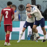 England's Jack Grealish, right, celebrates with England's Phil Foden after scoring his side's sixth goal during the World Cup group B soccer match between England and Iran at the Khalifa International Stadium in Doha, Qatar, Monday, Nov. 21, 2022. (AP Photo/Frank Augstein)