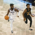 TCU guard Mike Miles Jr. (1) dribbles the ball down the floor past Arkansas-Pine Bluff guard Trejon Ware (0) in the first half of an NCAA college basketball game in Fort Worth, Texas, Monday, Nov. 7, 2022. (AP Photo/Emil Lippe)