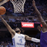 
              North Carolina guard R.J. Davis (4) drives to the hoop against James Madison forward Alonzo Sule (25) during the first half of an NCAA college basketball game Sunday, Nov. 20, 2022, in Chapel Hill, N.C. (AP Photo/Chris Seward)
            