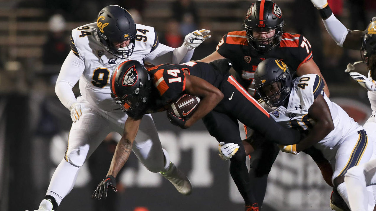 Oregon State wide receiver John Dunmore (14) is brought down by California safety Demetric Jackson ...