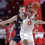 
              Houston forward J'Wan Roberts (13) passes the ball in front of Northern Colorado forward Riley Abercrombie, left, during the first half of an NCAA college basketball game Monday, Nov. 7, 2022, in Houston. (AP Photo/Michael Wyke)
            