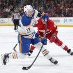 
              Buffalo Sabres right wing Jack Quinn (22) shoots as Detroit Red Wings left wing Tyler Bertuzzi (59) defends in the second period of an NHL hockey game Wednesday, Nov. 30, 2022, in Detroit. (AP Photo/Paul Sancya)
            