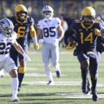 
              West Virginia safety Malachi Ruffin (14) intercepts the ball during the first half of an NCAA college football game against Kansas State in Morgantown, W.Va., Saturday, Nov. 19, 2022. (AP Photo/Kathleen Batten)
            