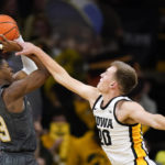 Georgia Tech guard Miles Kelly (13) is fouled by Iowa forward Payton Sandfort (20) during the second half of an NCAA college basketball game, Tuesday, Nov. 29, 2022, in Iowa City, Iowa. (AP Photo/Charlie Neibergall)