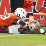 Florida State running back Trey Benson (3), right, scores a touchdown as Miami cornerback Te'Cory Couch (23) defends during the first half of an NCAA college football game, Saturday, Nov. 5, 2022, in Miami Gardens, Fla. (AP Photo/Lynne Sladky)