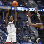 
              Connecticut's Nahiem Alleyne (4) shoots over Buffalo's LaQuill Hardnett (1) in the first half of an NCAA college basketball game, Tuesday, Nov. 15, 2022, in Hartford, Conn. (AP Photo/Jessica Hill)
            