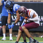 Virginia Tech's Mansoor Delane, right, intercepts a pass intended for Duke's Malik Bowen-Sims (18) during the first half of an NCAA college football game in Durham, N.C., Saturday, Nov. 12, 2022. (AP Photo/Ben McKeown)