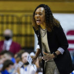 FILE - Kentucky head coach Kyra Elzy yells to her team as they play against Princeton in the first half of a college basketball game in the first round of the NCAA tournament in Bloomington, Ind., Saturday, March 19, 2022. The Atlantic Coast and Southeastern conferences have led the way among the power conferences in hiring coaches of color to lead women's basketball programs. (AP Photo/Michael Conroy, File)