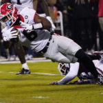 
              Georgia running back Kenny McIntosh (6) is tackled by a Mississippi State defender as he tries to get into the end zone during the first half of an NCAA college football game in Starkville, Miss., Saturday, Nov. 12, 2022. (AP Photo/Rogelio V. Solis)
            