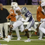 
              Kansas State cornerback Ekow Boye-Doe (25) knocks the ball out of the hands of Texas running back Roschon Johnson (2), creating a fumble that Kansas State recovered, during the first half of an NCAA college football game Saturday, Nov. 5, 2022, in Manhattan, Kan. (AP Photo/Reed Hoffmann)
            