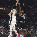 Los Angeles Clippers guard Paul George (13) shoots against San Antonio Spurs forward Isaiah Roby (18) during the first half of an NBA basketball game Saturday, Nov. 19, 2022, in Los Angeles. (AP Photo/Allison Dinner)